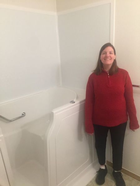 Happy customer next to her new walk in bathtub in Georgia (1)